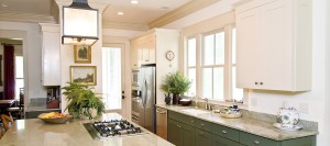 beautiful decorated kitchen with white and green cabinets