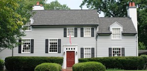 Modern house with red door and front entrance hedge.