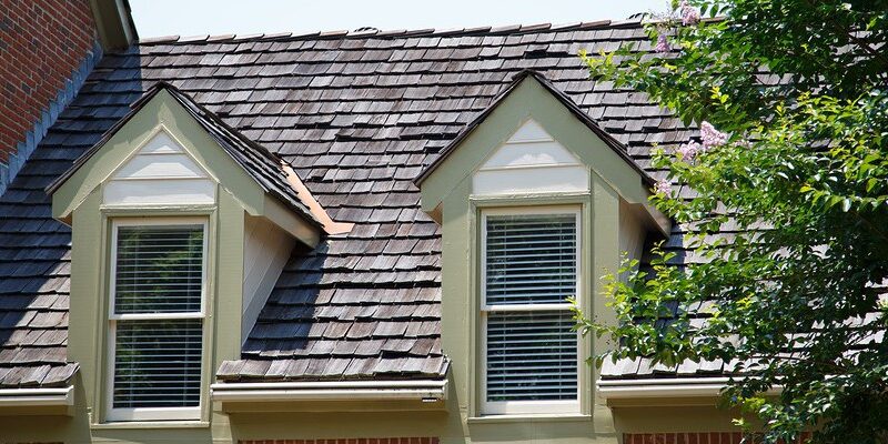 Two Dormers On Brick Homes With Wood Shingles Roofing Services
